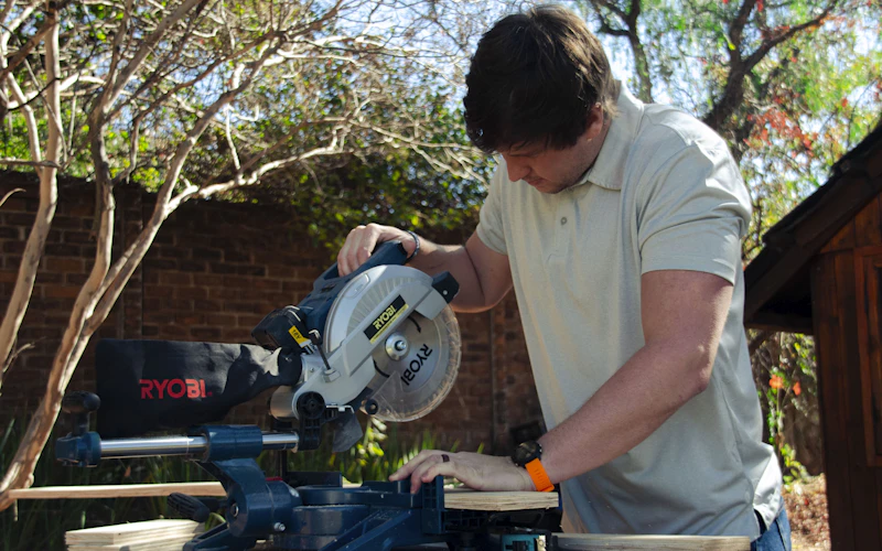 Carpenter working with a mitre saw (illustrative image)